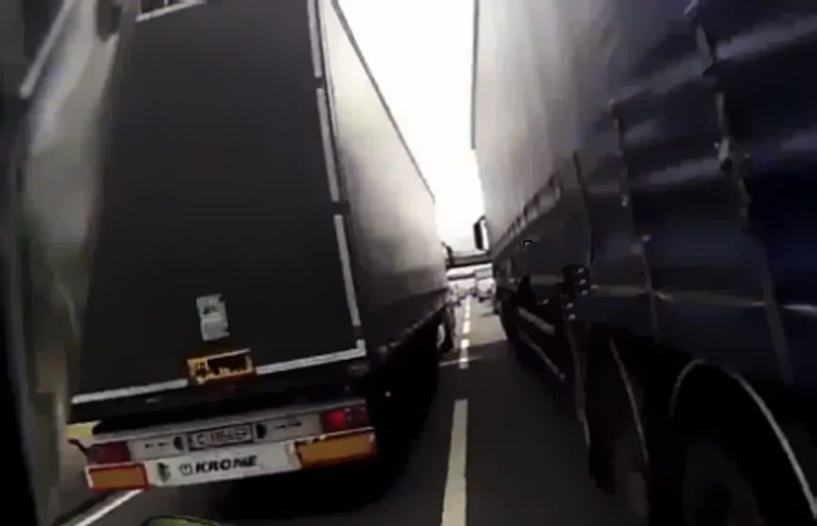Głupi biker wjeżdża między tiry
